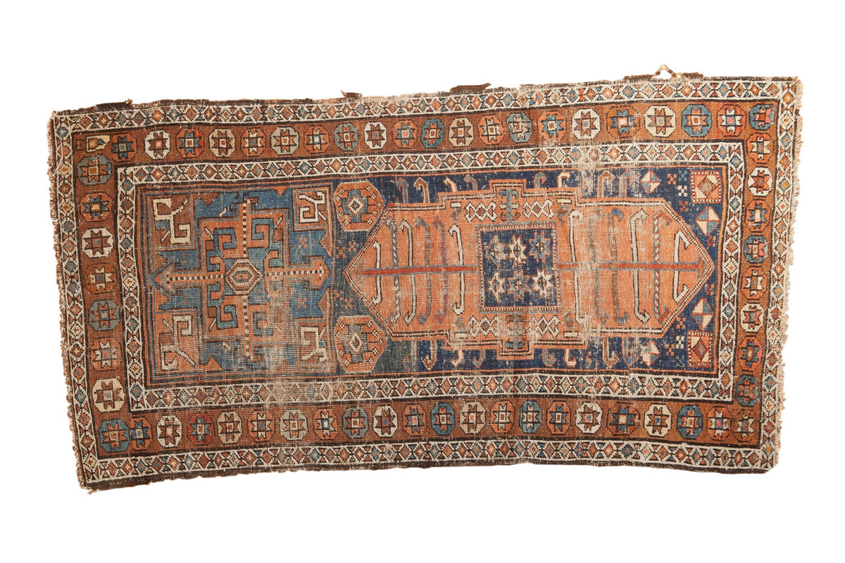 Antique Kurdish rug, asymmetric field, oversized medallions. Coffee, indigo, terracotta with even wear. 2'9" x 5'5".