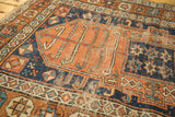 Terra cotta oblong medallion of antique Kurdish rug with visible foundation wear.