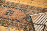 Tattered edge and geometric border of antique Kurdish rug with starburst motifs.
