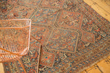 Vintage Kamseh rug detail with geometric panels, exposed foundation, and worn fringe.