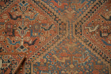 Hand-knotted vintage Kamseh rug detail: panel design featuring stylized birds, snakes, and geometric lattice in terra cotta, blue, and brown tones.