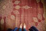 Hand knotted vintage Amritsar rug with worn wine red pile and detailed oblong patterns.