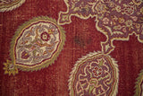 Detail of vintage Amritsar carpet showing worn wine red pile and intricate oblong motifs.