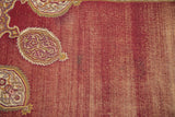 Vintage Amritsar carpet's wine red field, worn to foundation, with a mauve and ivory pattern detail.