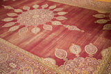 Amritsar rug corner detail with worn wine red field, spandrel, and cartouche border.