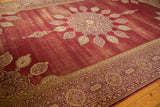 Repeating cartouche and pomegranate border on the vintage rug's reconciled corner.