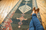 Interlaced samovar motifs in a vintage Kurdish Bijar rug's central diamond medallion.