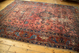 Antique Lilihan carpet end showing raspberry field, sapphire border, and exposed foundation.