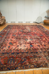 Antique Lilihan rug's sapphire blue border with delicate vinery, raspberry field, ivory fringe.