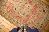 Antique Kerman rug border with serrated leaves, tatter, and visible patch.