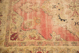 Antique Kerman rug with four-inch patch, visible foundation, and faded cochineal palmette motifs.