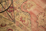 Antique Kerman rug's curvilinear design featuring cochineal red palmettes and serrated leaves.