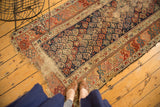 Antique Kurdish Hamadan runner detail: indigo boteh field, multicolor geometric borders, threadbare pile.