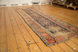 Antique Kurdish Hamadan runner: wear, tattered fringe, and red geometric border.