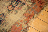 Antique Kurdish Hamadan runner with extensive wear, geometric border, and tattered fringe.