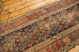 Extensive wear on antique Kurdish Hamadan runner's indigo field and repeating boteh motifs.
