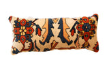 Extra Long Lumbar Rug Fragment Pillow with cream, navy, rust, and orange stylized patterns.