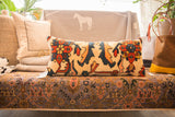 Lumbar pillow's right half, featuring bold terracotta, navy, and gold stylized rug patterns.
