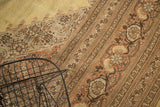 Vintage Tabriz rug's serrated border with floral motifs in pale gold, rust, and brown.