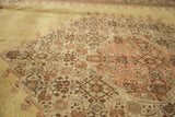 Pale gold Tabriz carpet field with intricate rust, brown flowers and serrated medallion.