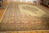 Vintage Tabriz rug's detailed pale rust and chocolate floral border with original side selvage.