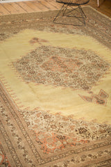 Vintage Tabriz carpet, pale gold field with diamond medallion and rust brown floral patterns.