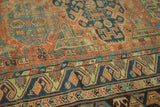Antique Caucasian Soumac rug detail: geometric pattern in brick red, indigo, and ivory.
