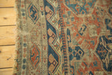 Antique Caucasian Soumac flat weave with tattered edge, exposed foundation, and red and indigo motifs.