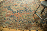 Antique Caucasian Soumac carpet's geometric motifs in brick red, indigo, and tattered fringe.