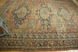 Geometric borders of this antique Soumac rug, displaying indigo, brick red, and saffron motifs.