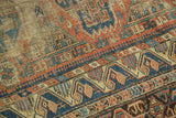 Antique Caucasian Soumac rug's flatweave texture and geometric motifs in brick red and indigo.