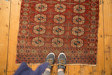 Antique Turkmen rug's wine red field, repeating geometric gul (elephant footprint) motifs.