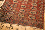 Antique Turkmen rug, triple column gul motif, geometric borders, deep reds, navy, and aged fringe.