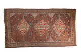 Antique Shiraz carpet, triple stepped medallion, tribal patterns in a rich red, ivory, and navy palette.