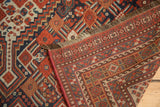Hand-knotted antique Shiraz carpet corner revealing tribal patterns, woven foundation, and fringe.