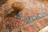 Antique Karaja carpet's rectilinear patterns in brick red, sky blue, ivory, with surface wear.
