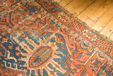 Antique Karaja carpet end, revealing brick red, blue geometric patterns with foundation wear.