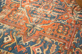 Antique Karaja rug detail: rectilinear palmette pattern in brick red and sky blue, with wear.