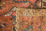 Antique Karaja rug close-up: brick red and blue pile, exposed woven foundation, tattered edge.