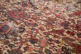 Heriz rug detail: unusual ivory field, serrated leaf and turtle motifs, showing even wear.