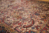 Vintage Heriz carpet with intricate serrated leaf motifs, traditional turtle border, and ivory field.