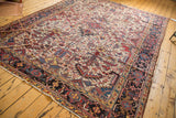 Dark navy traditional turtle border with meandering vines and ivory field of vintage Heriz rug.