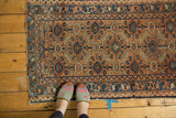 Visible edge wear on antique Persian Lilihan rug with geometric apricot, blue, ivory pattern.