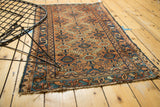Antique Lilihan rug detail: apricot field, blue geometric concentric circles, ivory motifs, tattered side.