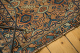 Tattered edge of a circa 1920s Lilihan rug with apricot, sky blue geometric motifs.