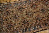 Apricot and sky blue geometric motif on antique Lilihan rug. Worn edge.