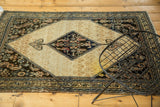 Antique Malayer Serab ivory field with navy herati medallion, rams horn motif, and visible stain.