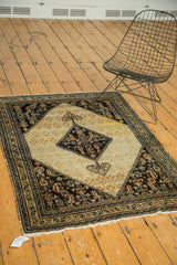 Antique Malayer Serab rug with ivory medallion, dark navy field, and visible highlighter stain.