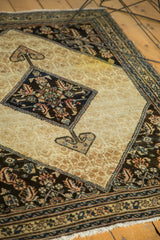 Antique Malayer Serab rug, dark navy herati medallion, ram's horn, ornate ivory field, visible stain.
