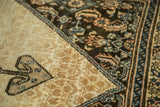 Antique Malayer Serab rug showing ram's horn motif, tone-on-tone beige field, dark navy border.